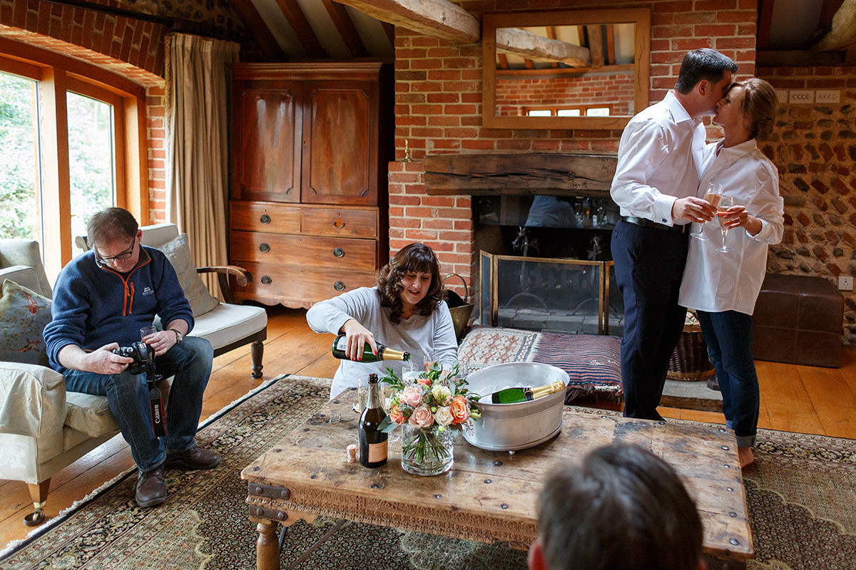 the bride and groom kiss inside chaucer barn