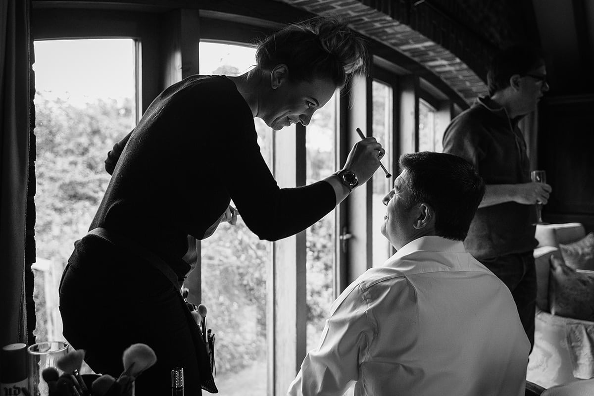 the groom has his makeup applied