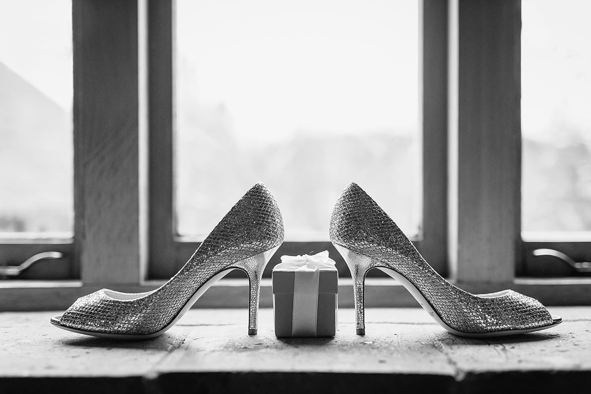 the brides shoes backlit by a window