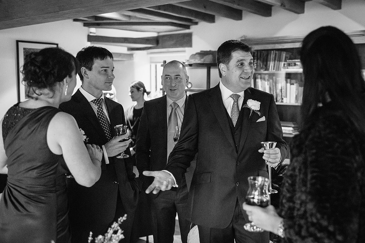 the groom greets guests before the wedding ceremony