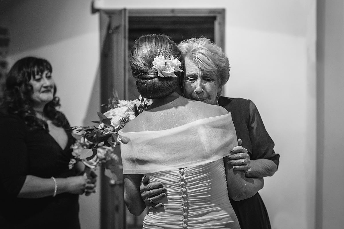 the bride and her mother embrace