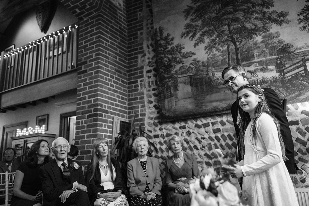 the flowergirl reads during a chaucer barn wedding ceremony