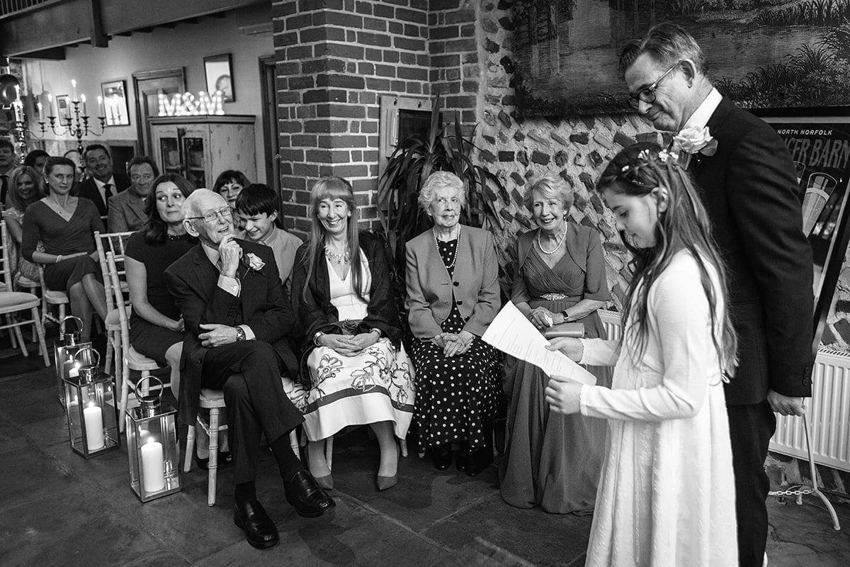 the flowergirl reads during a chaucer barn wedding ceremony