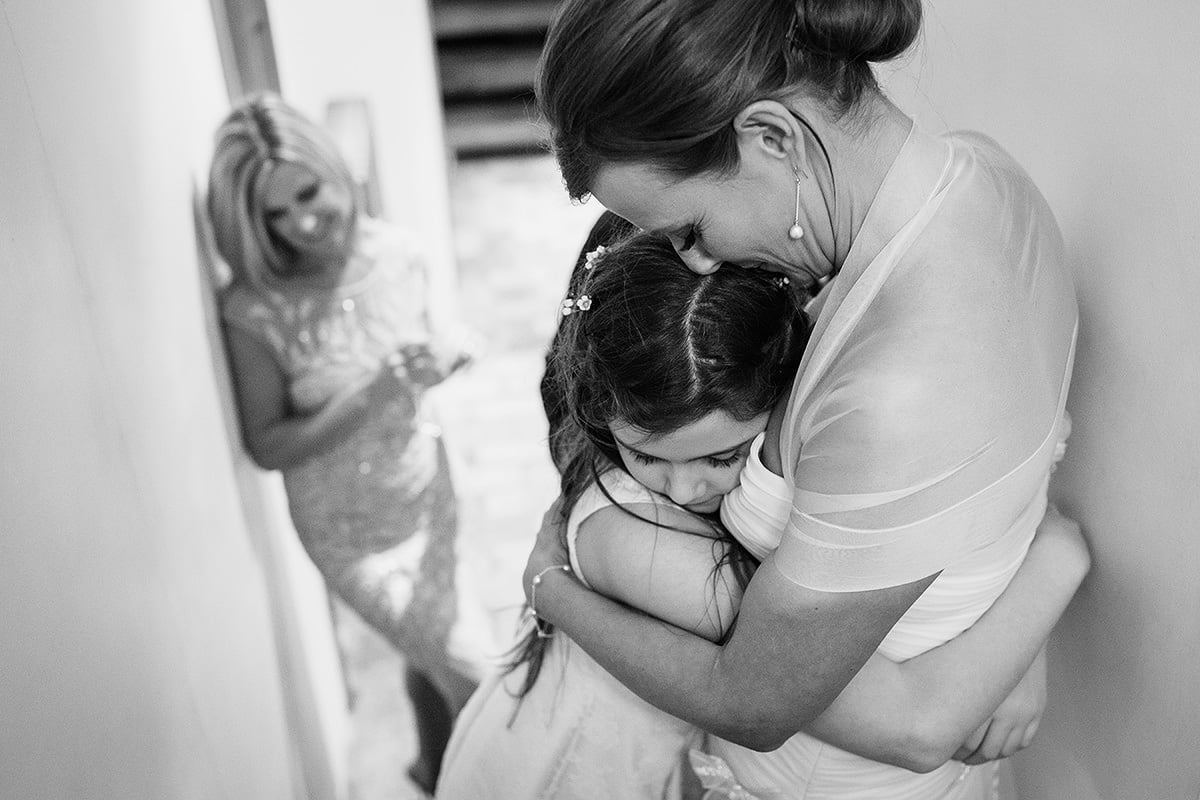 the bride hugs her daughter