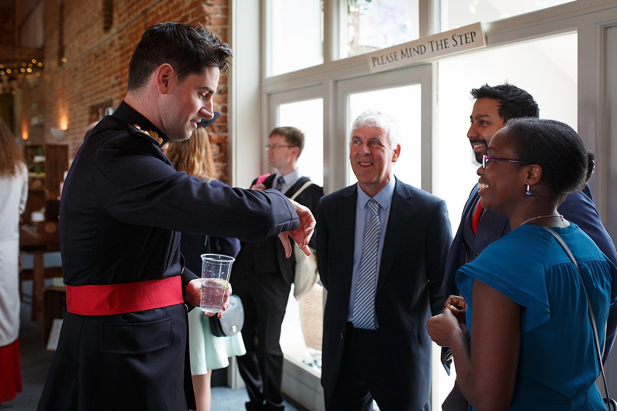 rob checks his watch while greeting guests