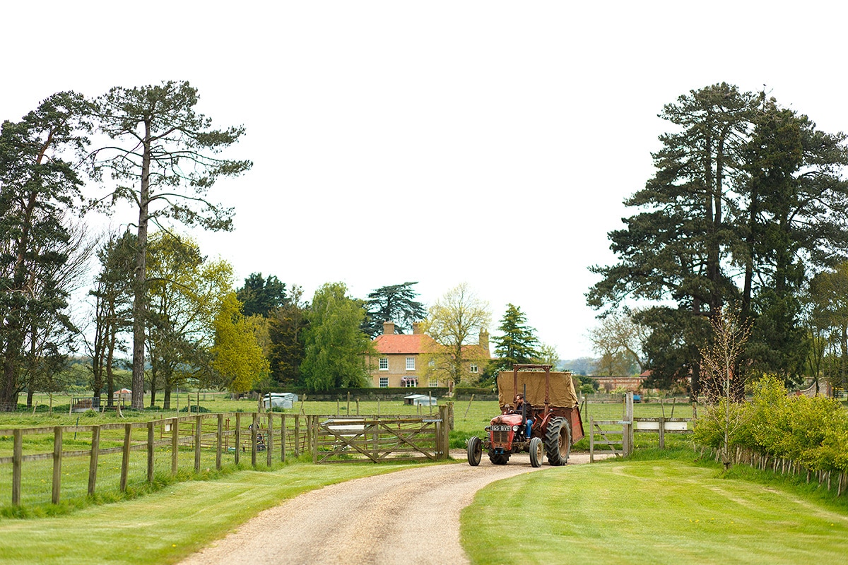 the bride rides to godwick barn on a tractor