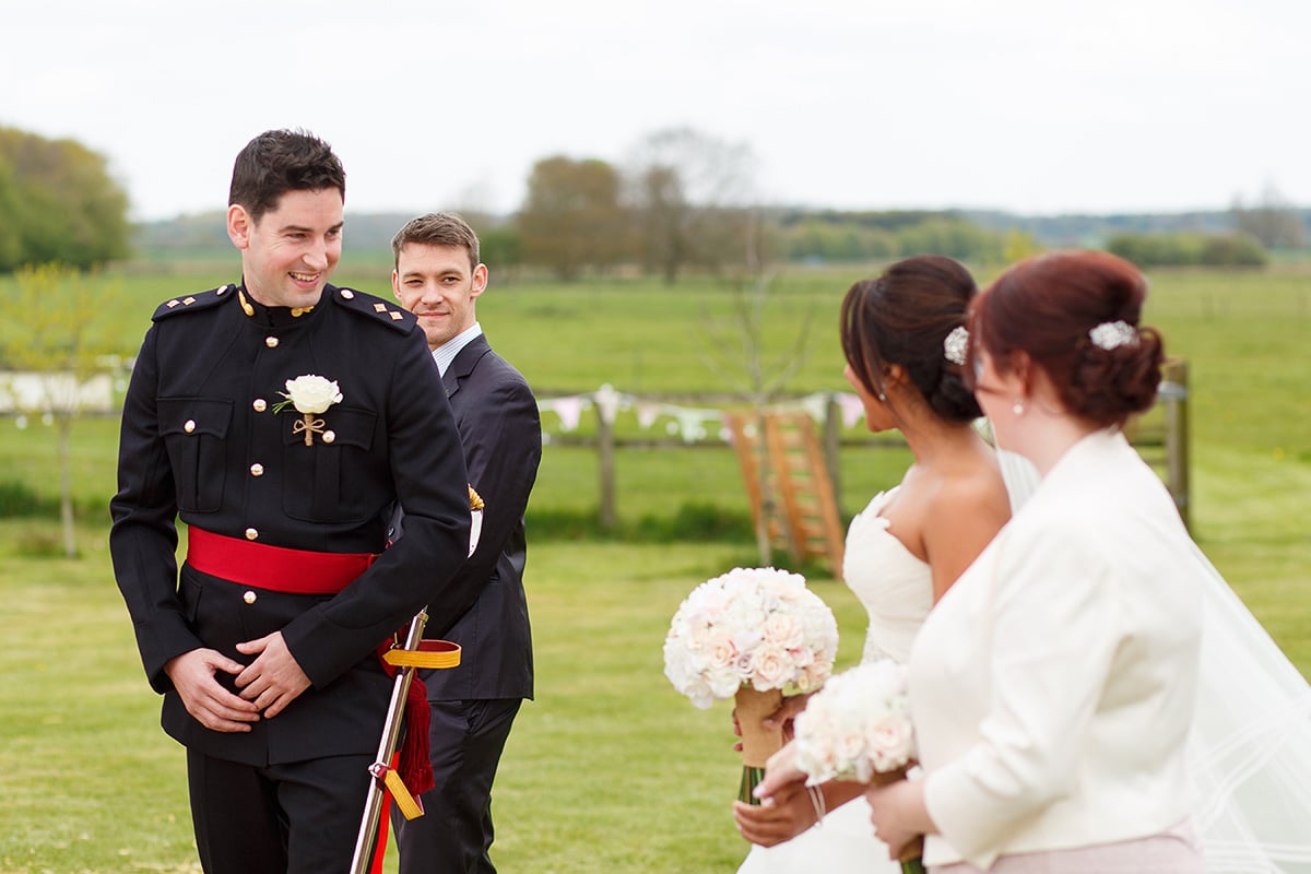 the grooms first look at the bride at the end of the aisle