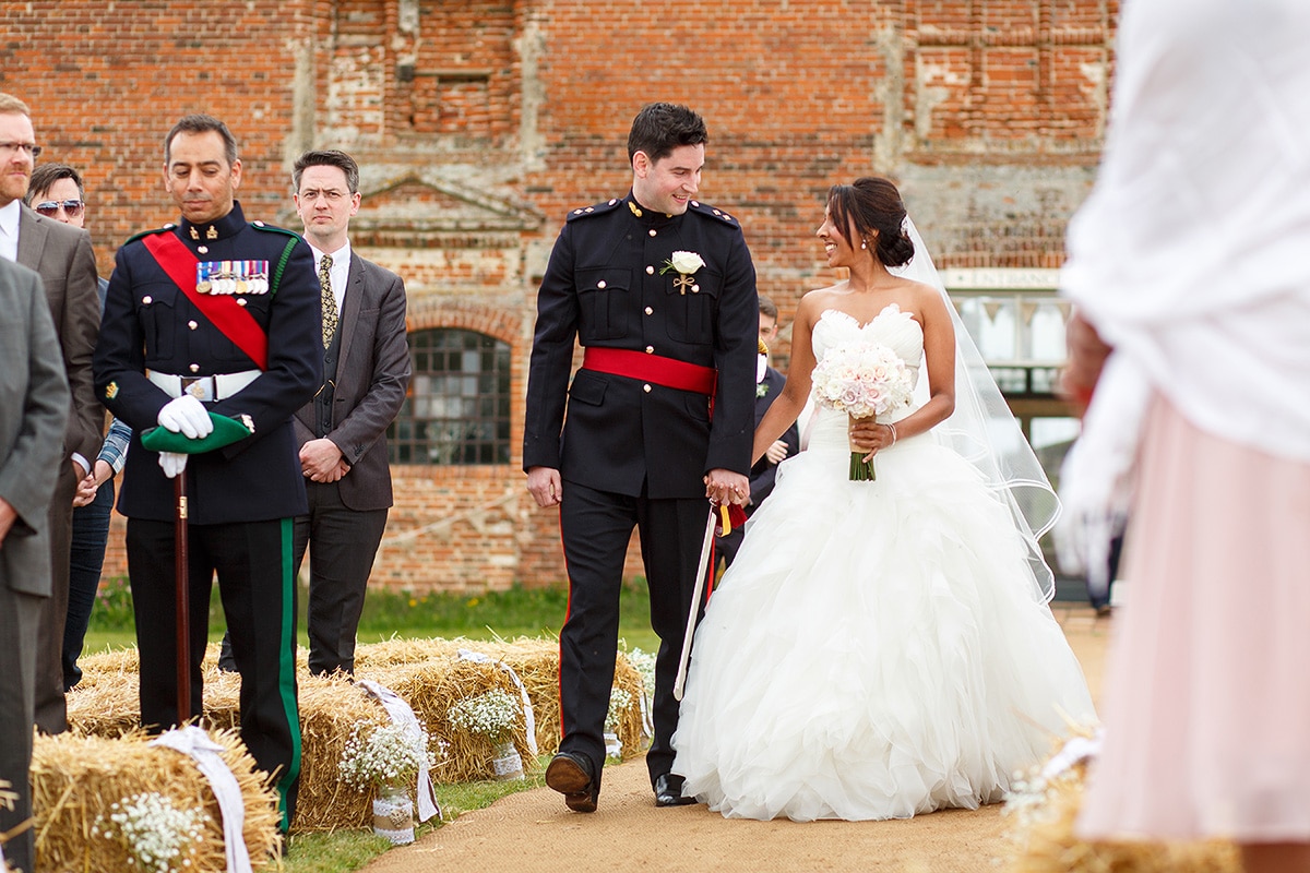 bride and groom walk up the aisle together