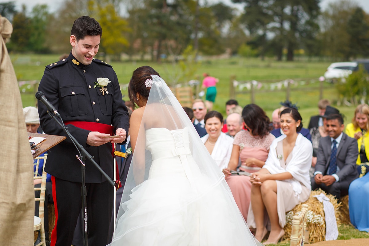 the bride laughs as the groom reads his vows