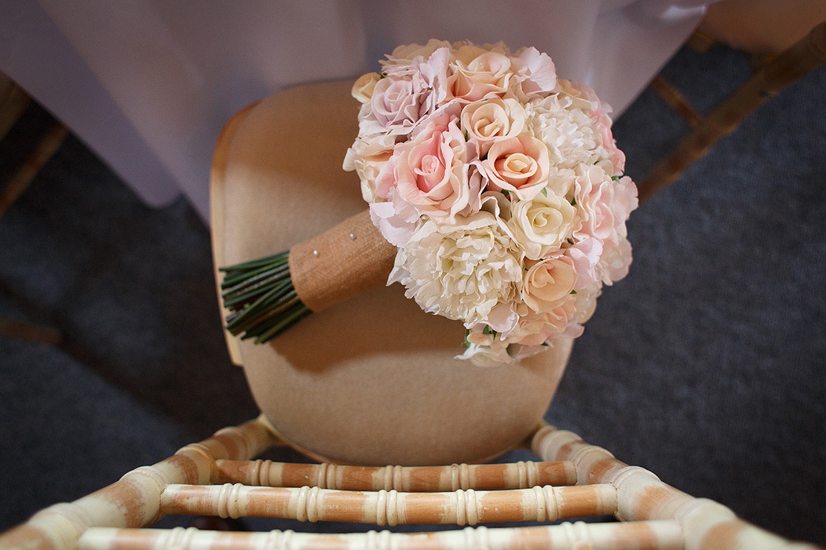 the brides flowers left on her chair inside the barn
