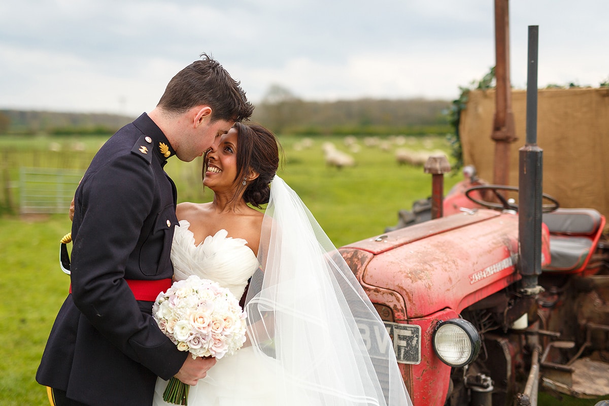 a portrait of the bride and groom with the tractor