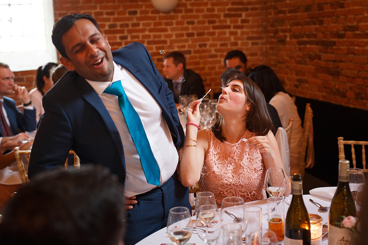 wedding guests playing with bubbles