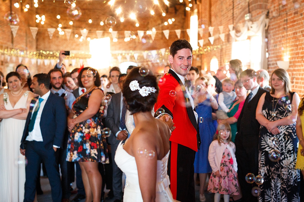 the groom looks at the bride during the first dance