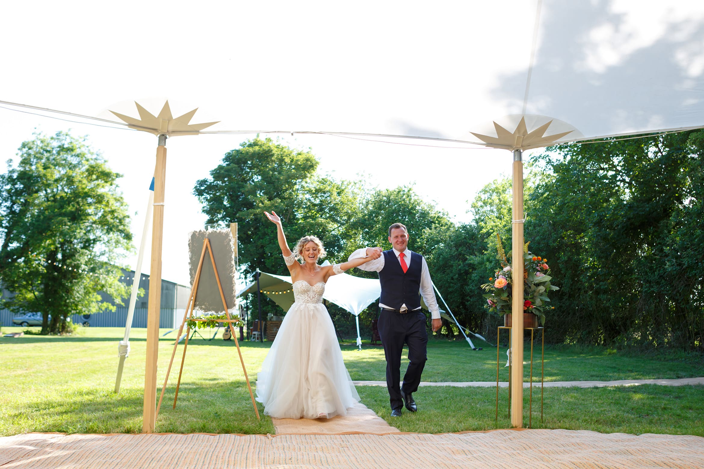 bride and groom enter the marquee