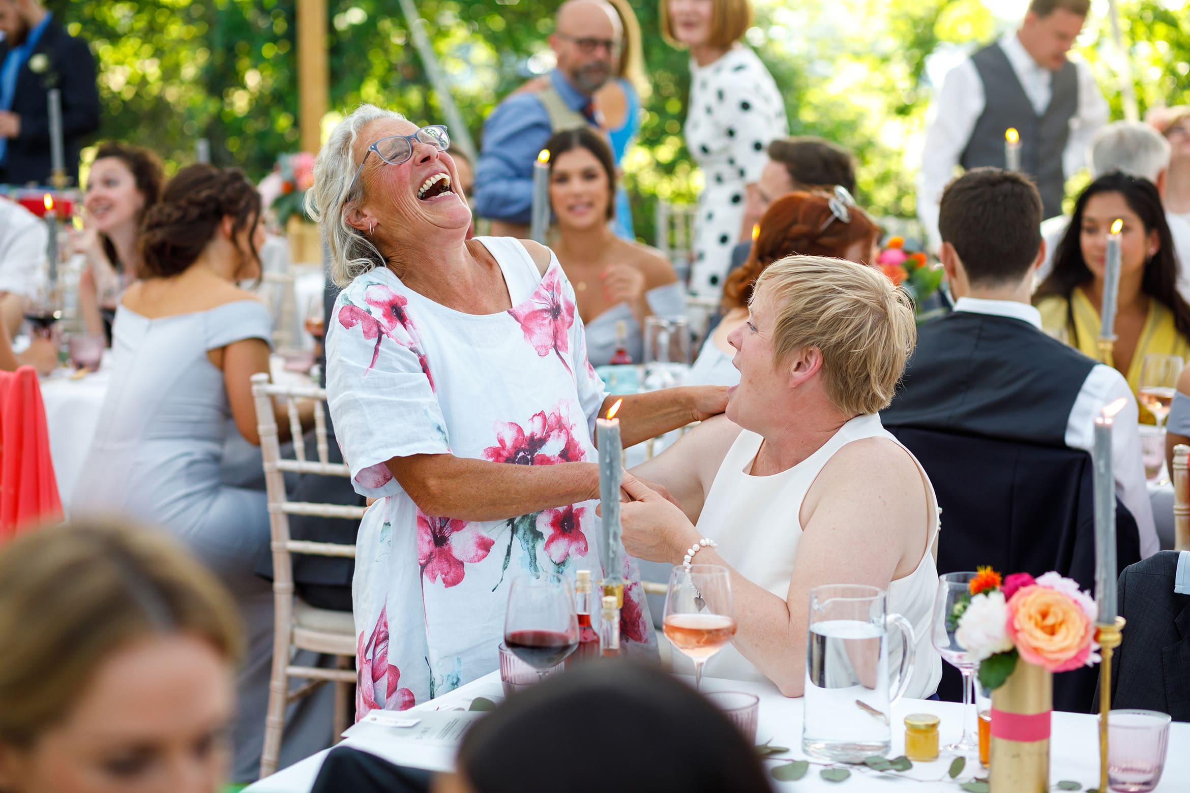 tow wedding guests share a joke