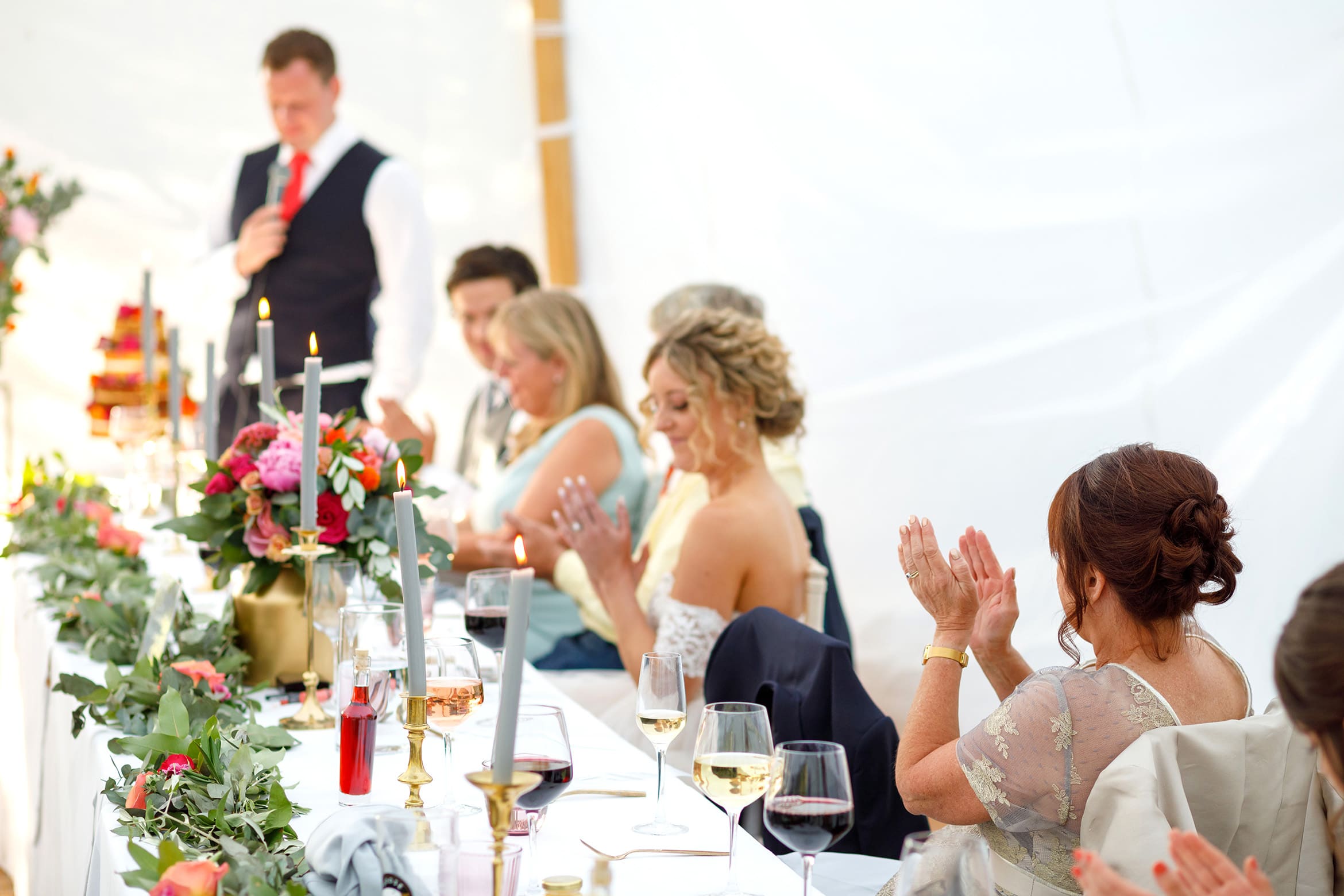 the mother of the bride applauds the groom