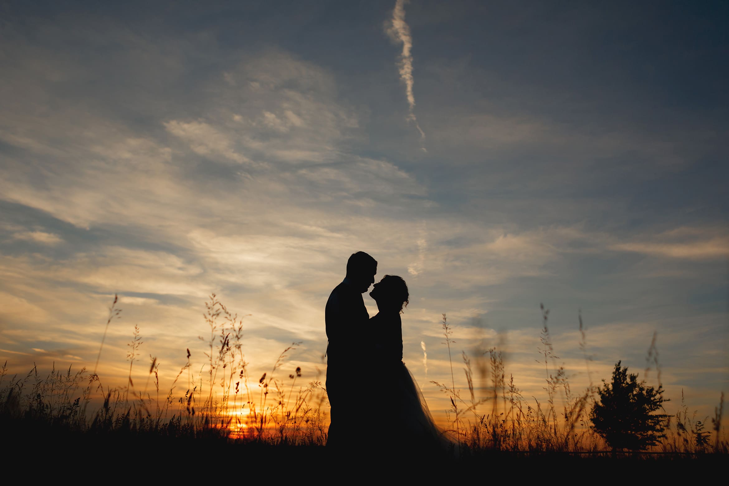 bride and groom in a summer solstice wedding sunset silhouette