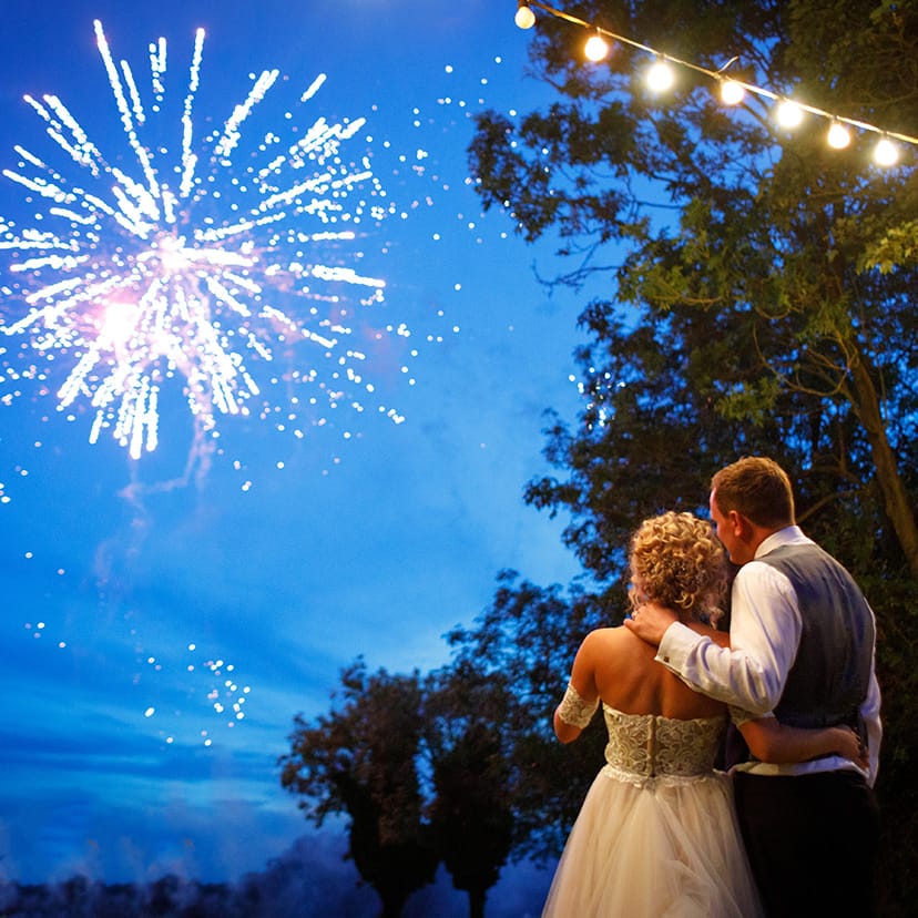 bride and groom watching fireworks
