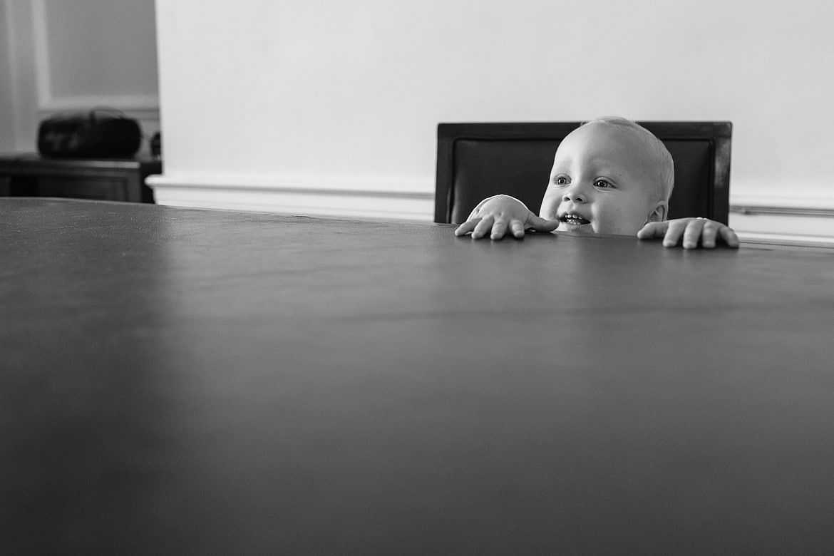 a baby looking over the ceremony table