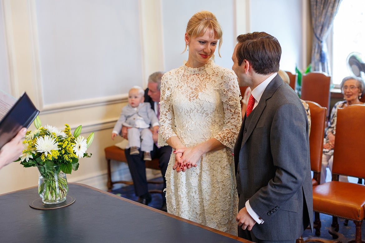 the bride smiles at the groom at the start of their wedding ceremony