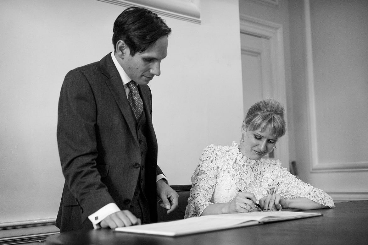 bride and groom sign the wedding register