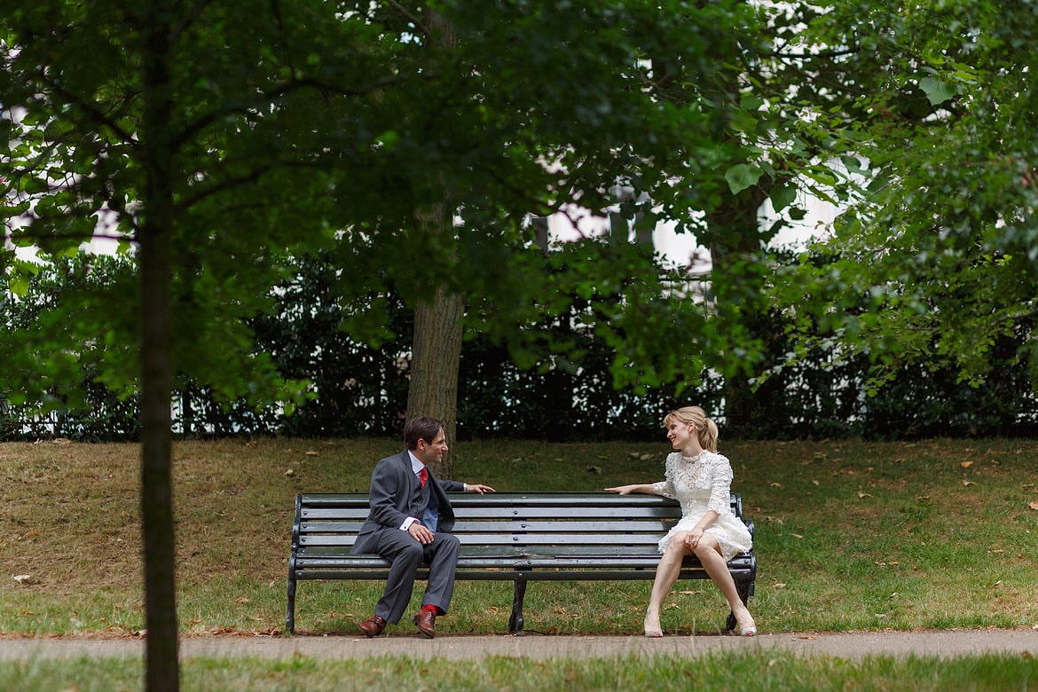 wedding couple sitting on a bench