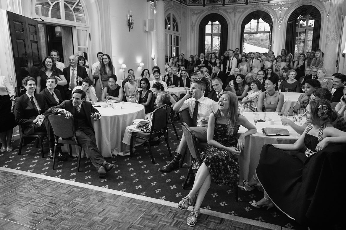 wide shot of the wedding guests enjoying rowenas speech