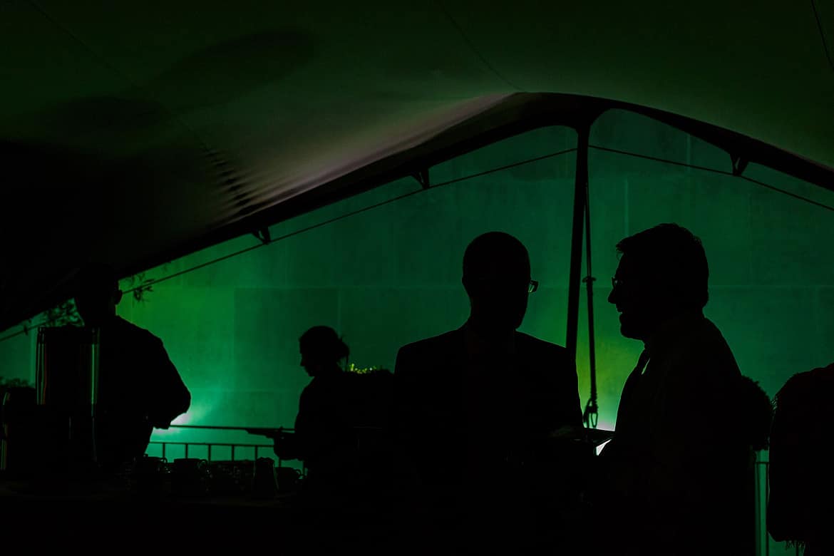 guests talk in the evening under the canopy