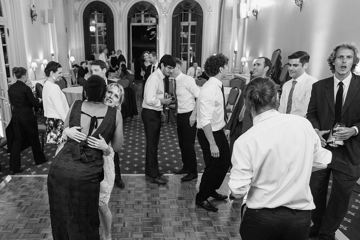 the bride makes a funny face as she embraces a guest