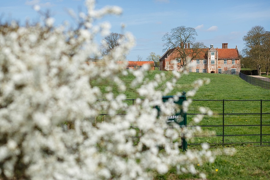 bruisyard hall seen through spring blossom