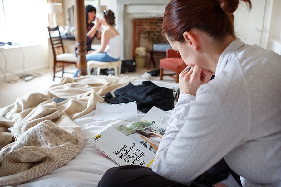 a bridesmaid reads an article in a wedding magazine