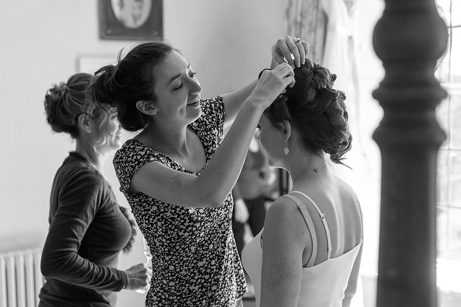 laura fixes a bridesmaids hair