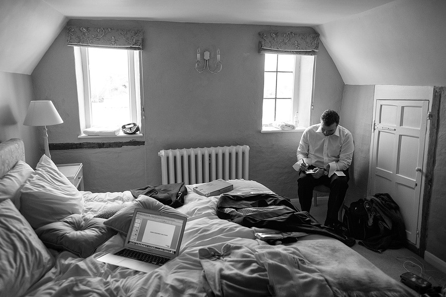 the groom sits alone and writes his speech