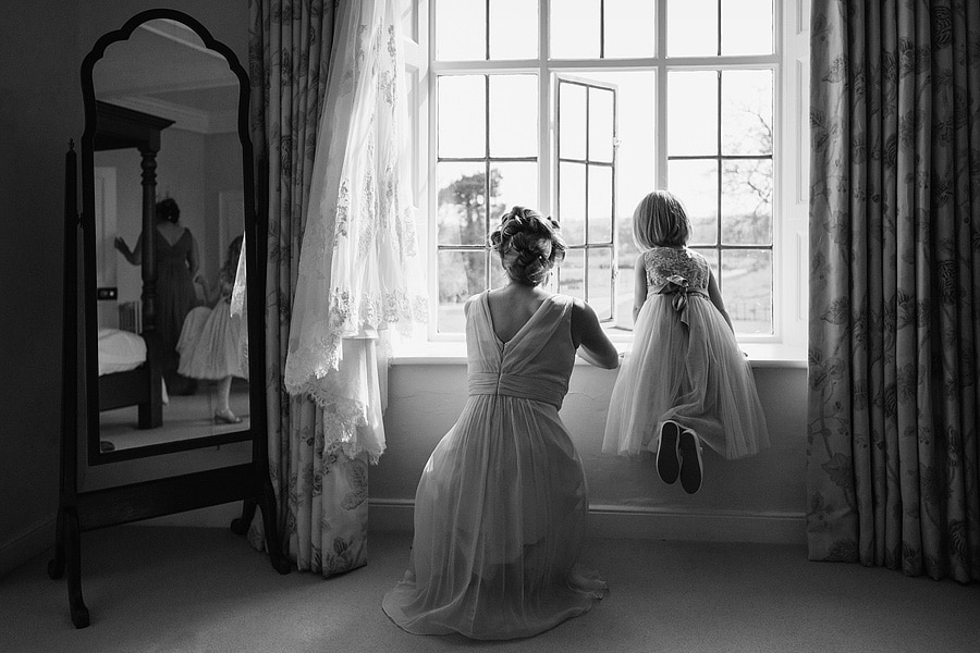 a flowergirl looks out of the window