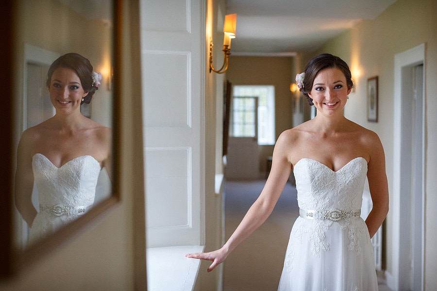 the bride posing in the hallway at Bruisyard Hall