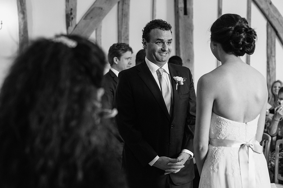 the groom smiles at his bride