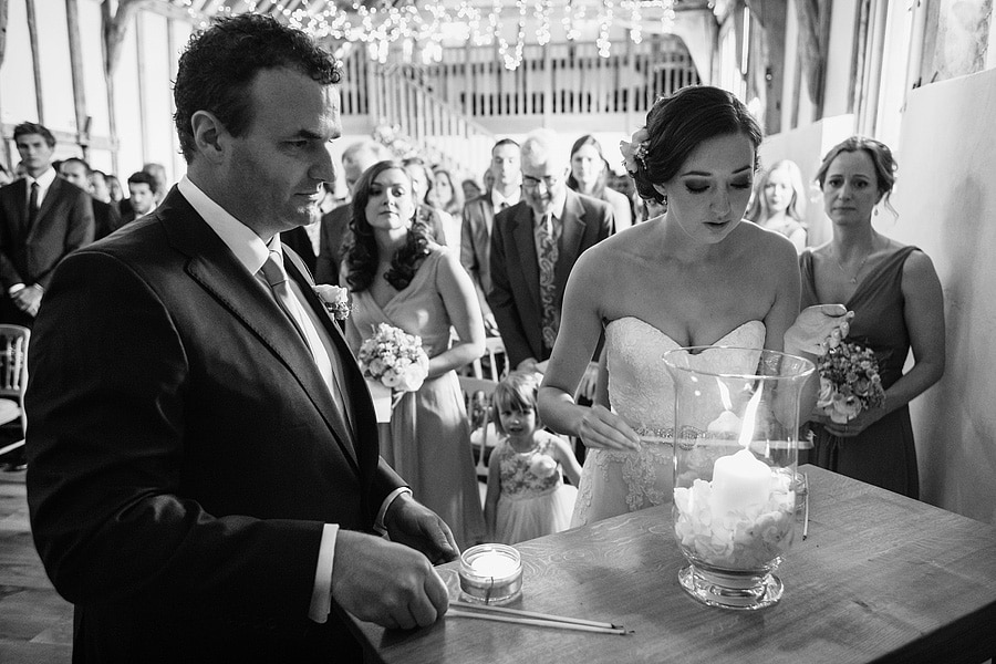 laura and brooks light the ceremony candles