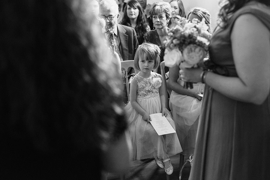 a flowergirl looks on