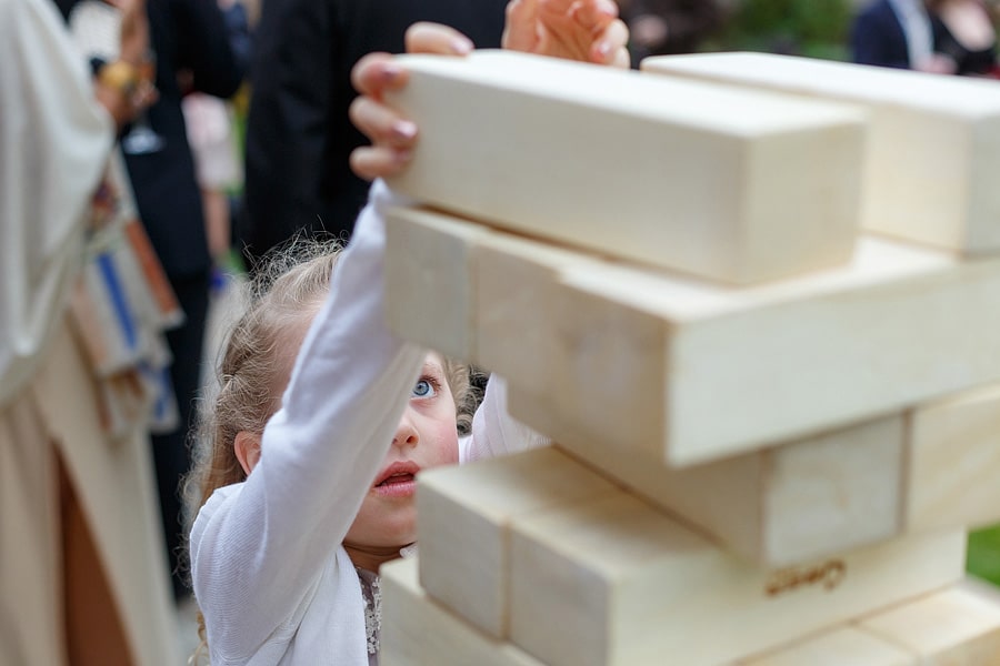 a flowergirl plays jenga