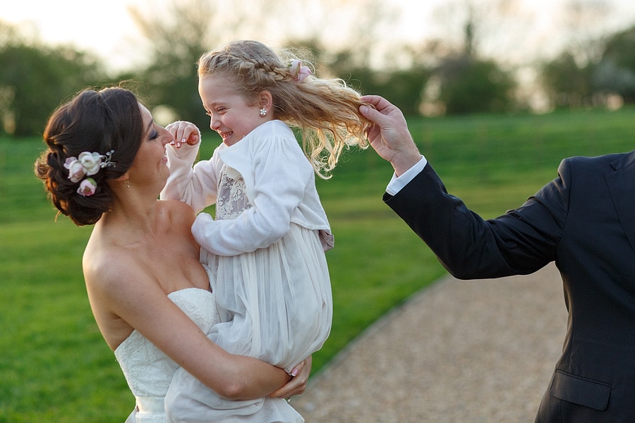 the bride holding a smiling flowergirl