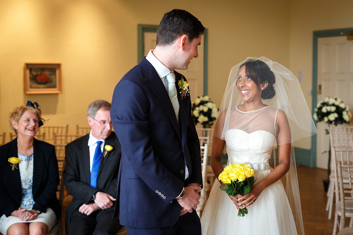 bride and groom greet each other at the beginning of the ceremony