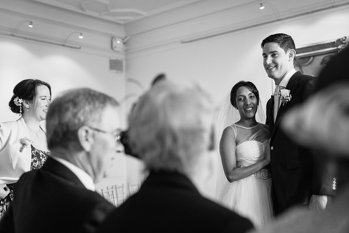 sam and rob smile at their family after the ceremony