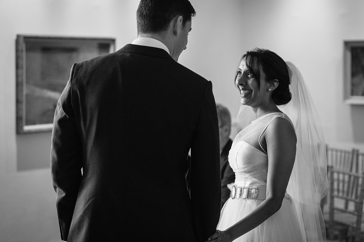 the bride and groom exchange happy smiles