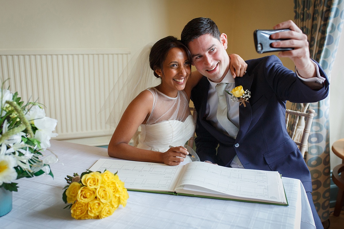 bride and groom selfie after signing the register