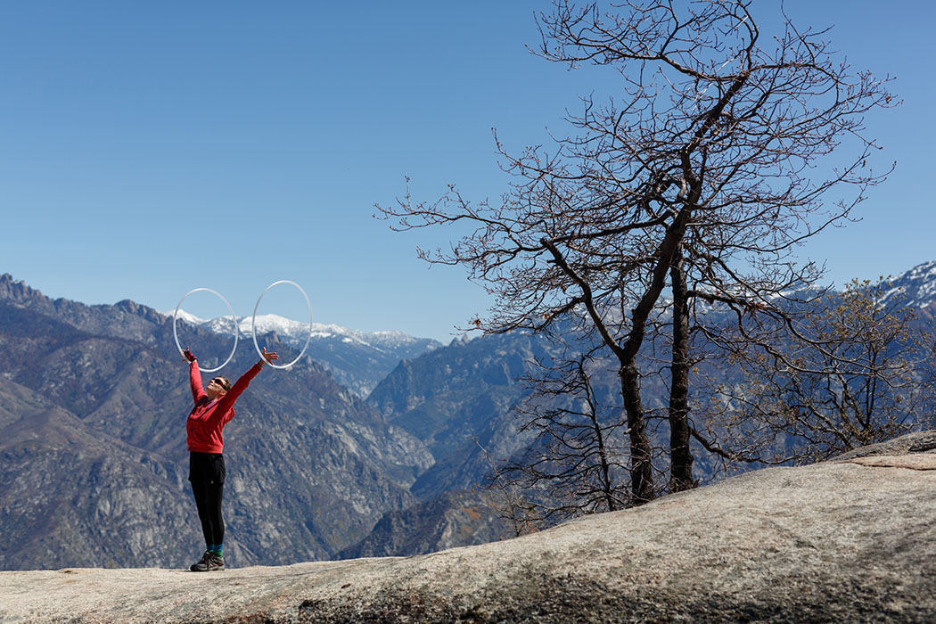 girl with hula hoops in front of a mountain