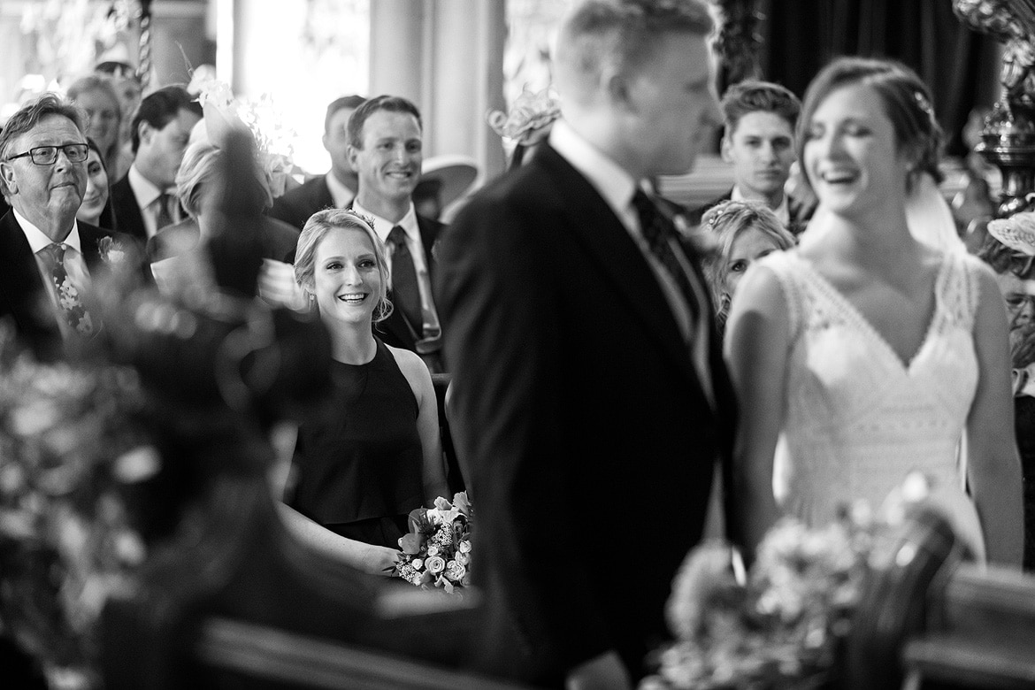 the brides sister smiles during the wedding ceremony