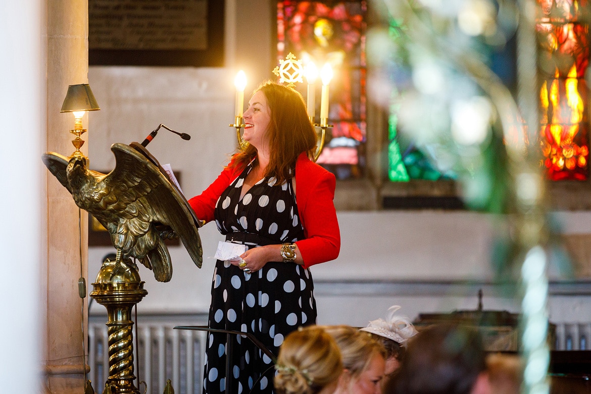 a guest reads during the ceremony