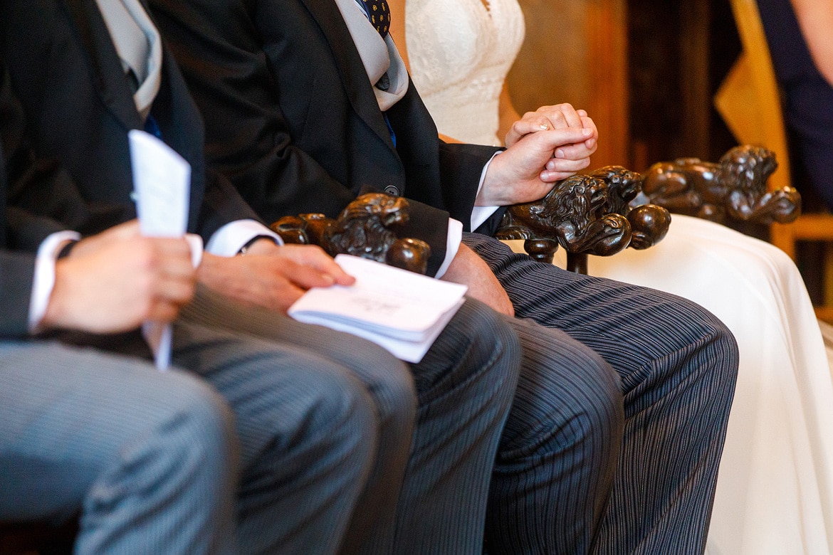 bride and groom hold hands