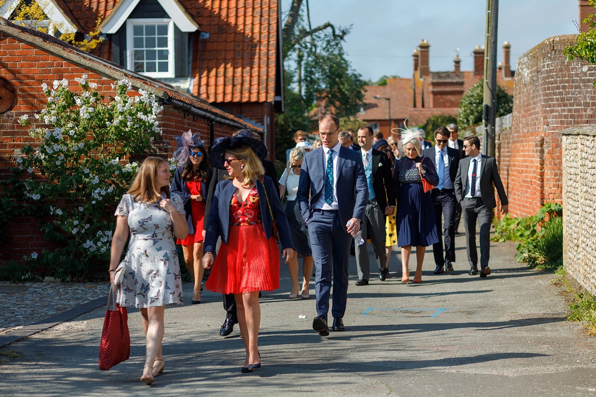 wedding guests walking through the street of aldeburgh
