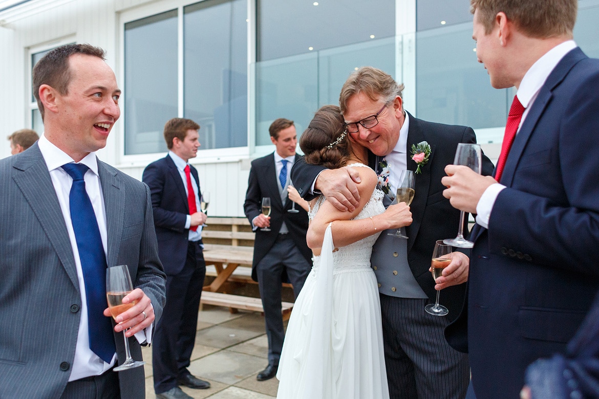 the bride hugs her father after his speech